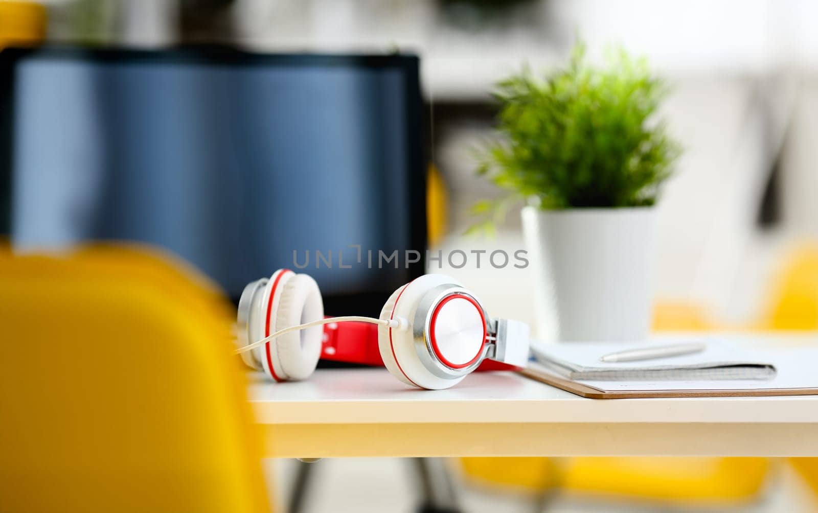 Empty remote office workplace with laptop pc and headset closeup. Receptionist or secretary of contact data center desktop keyboard device desk table ip telephony or callcenter voice message system