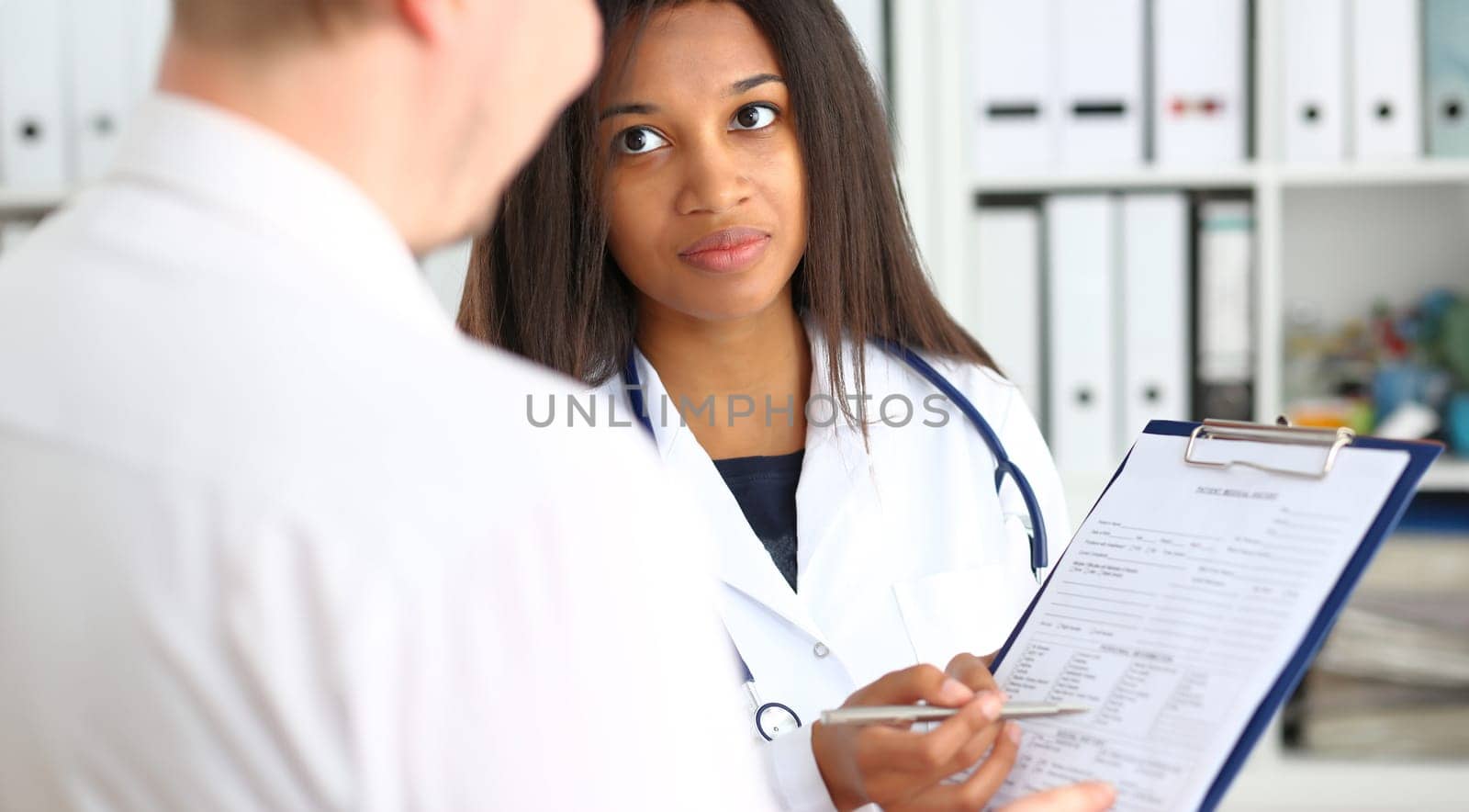 Female doctor hand hold silver pen and showing pad. Physical agreement form signature disease prevention ward round reception consent contract sign prescribe remedy healthy lifestyle concept