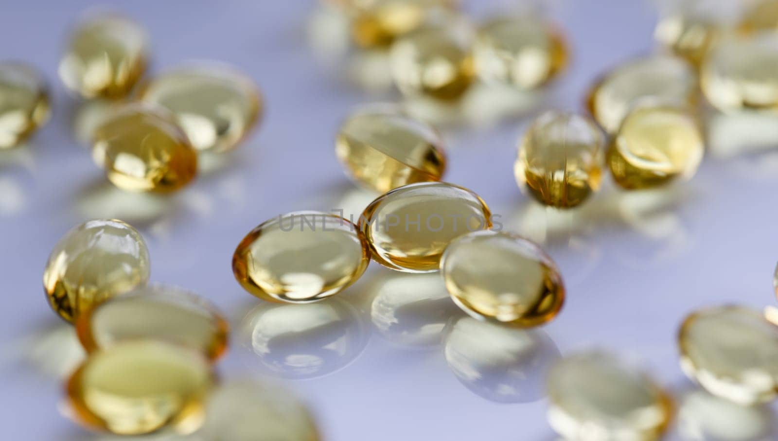 Tablets scattered yellow fish oil on table of the pharmaceutical laboratory pill for the prescription and treatment of various diseases chemistry