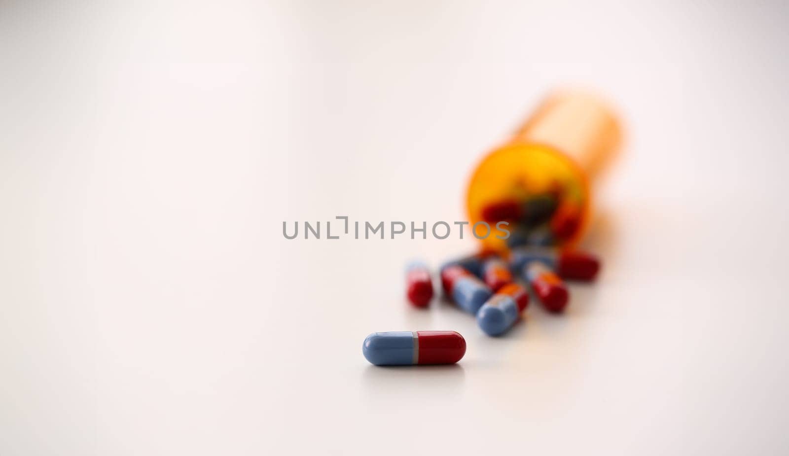 Tablets scattered blue and red color jar on the table of pharmaceutical laboratory pill for the prescription and treatment various diseases chemistry