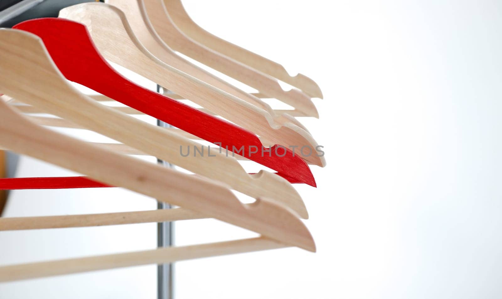 Red and wooden hanger hanging on metal by kuprevich