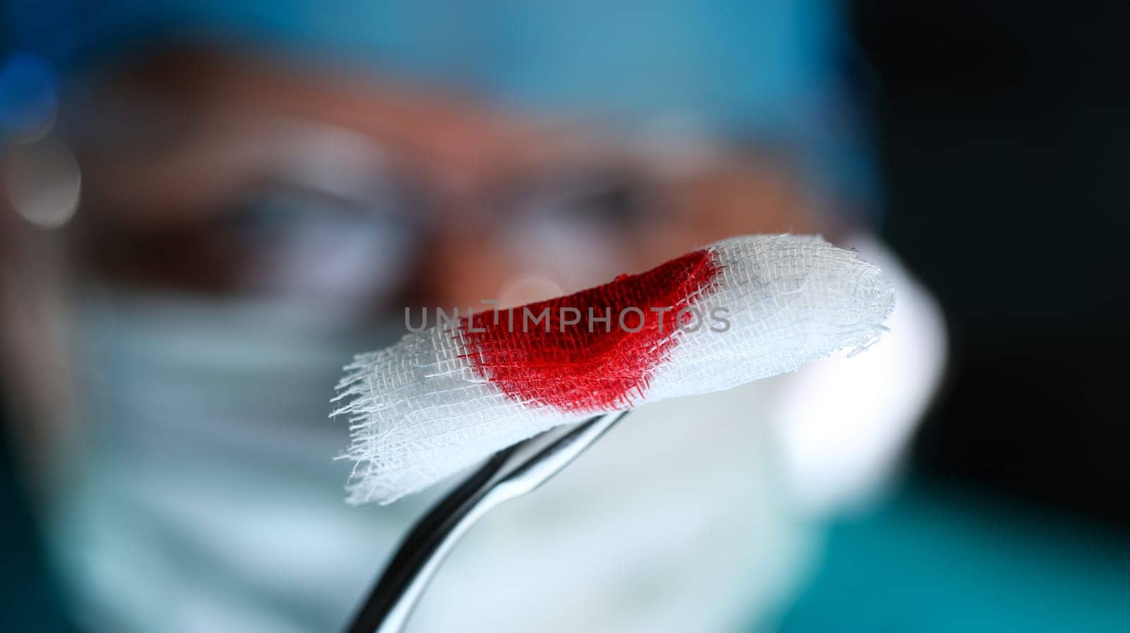 Surgeon in sterile uniform arms holding tools with bio material by kuprevich