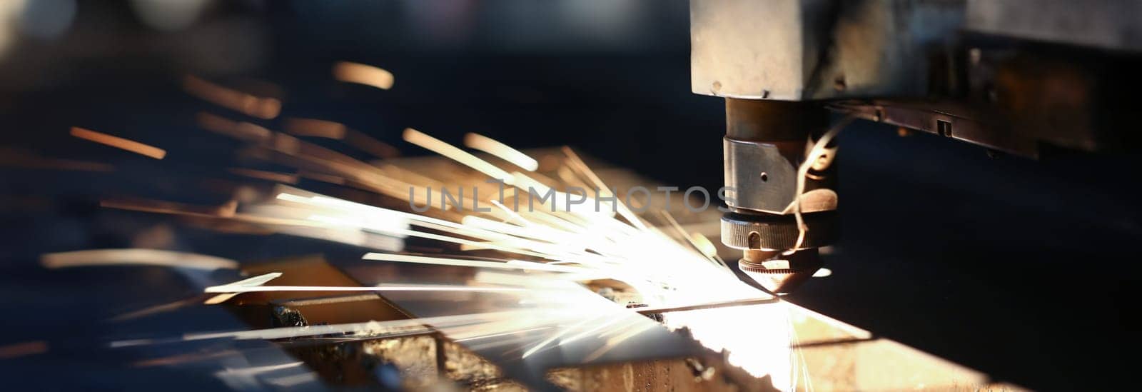Sparks fly out machine head for metal processing by kuprevich