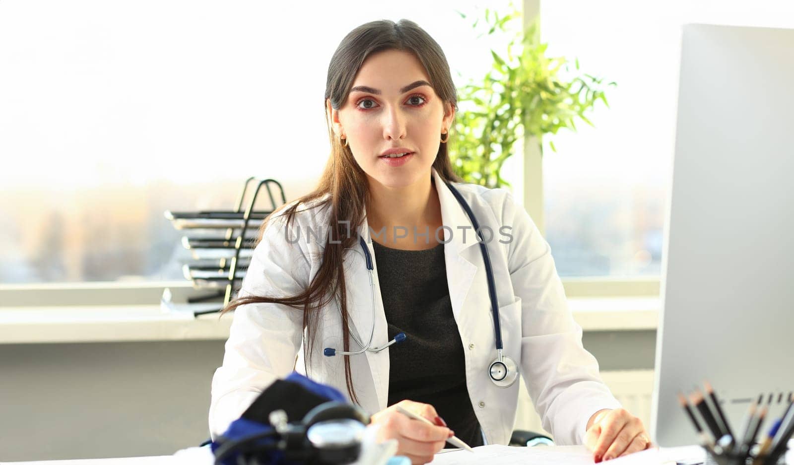 Female medicine doctor hand holding silver pen by kuprevich