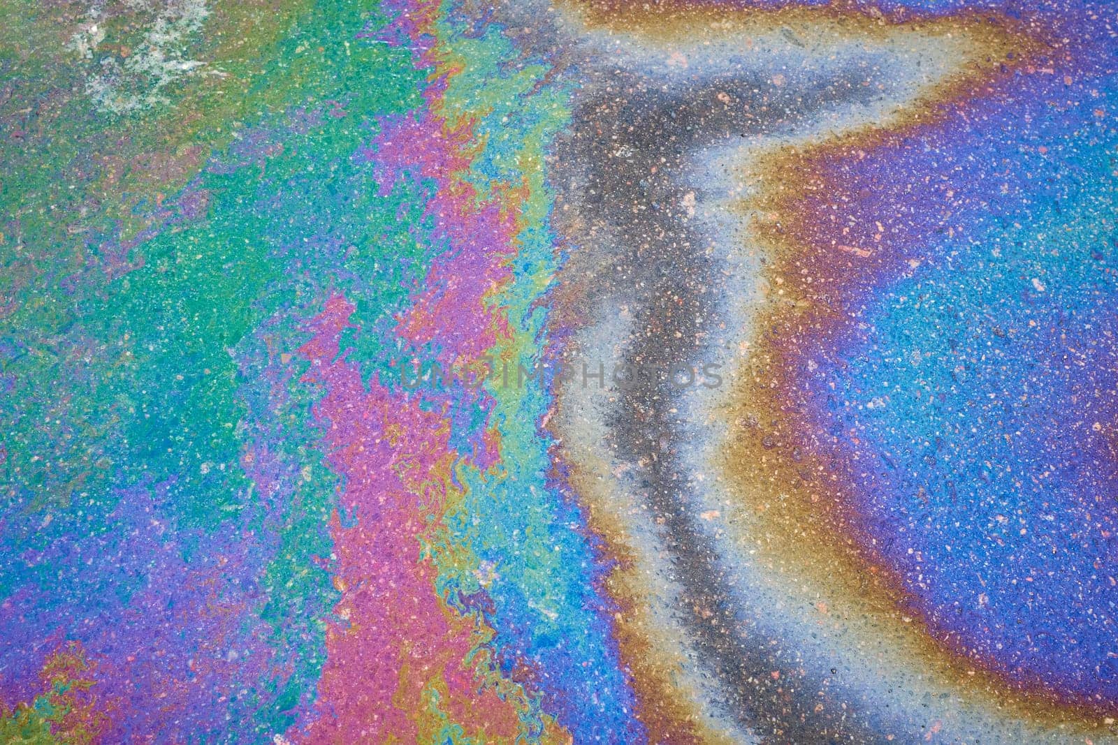 The oil left behind after rain forms spots that refract the sun's spectrum like a rainbow