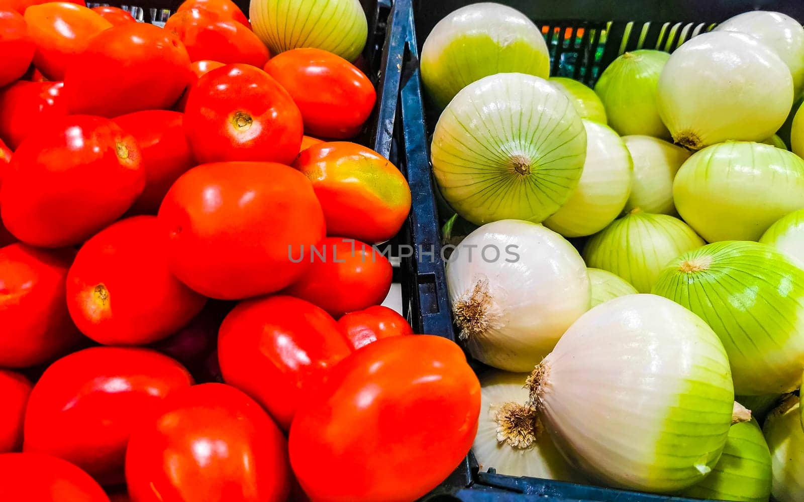 Tomatoes tomatoes and onions onions vegetables on the market in Zicatela Puerto Escondido Oaxaca Mexico.