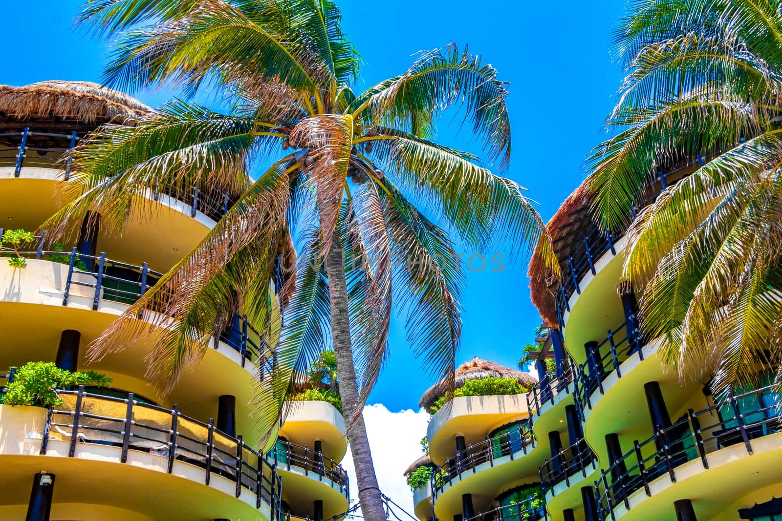 Huge resort and hotel complex on Caribbean beach sea and palm trees in Playa del Carmen Quintana Roo Mexico.