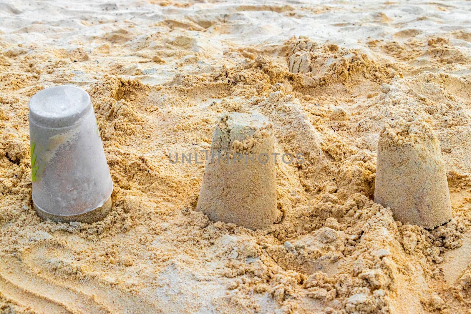 Castle made of white sand with buckets on the beach in Playa del Carmen Quintana Roo Mexico.