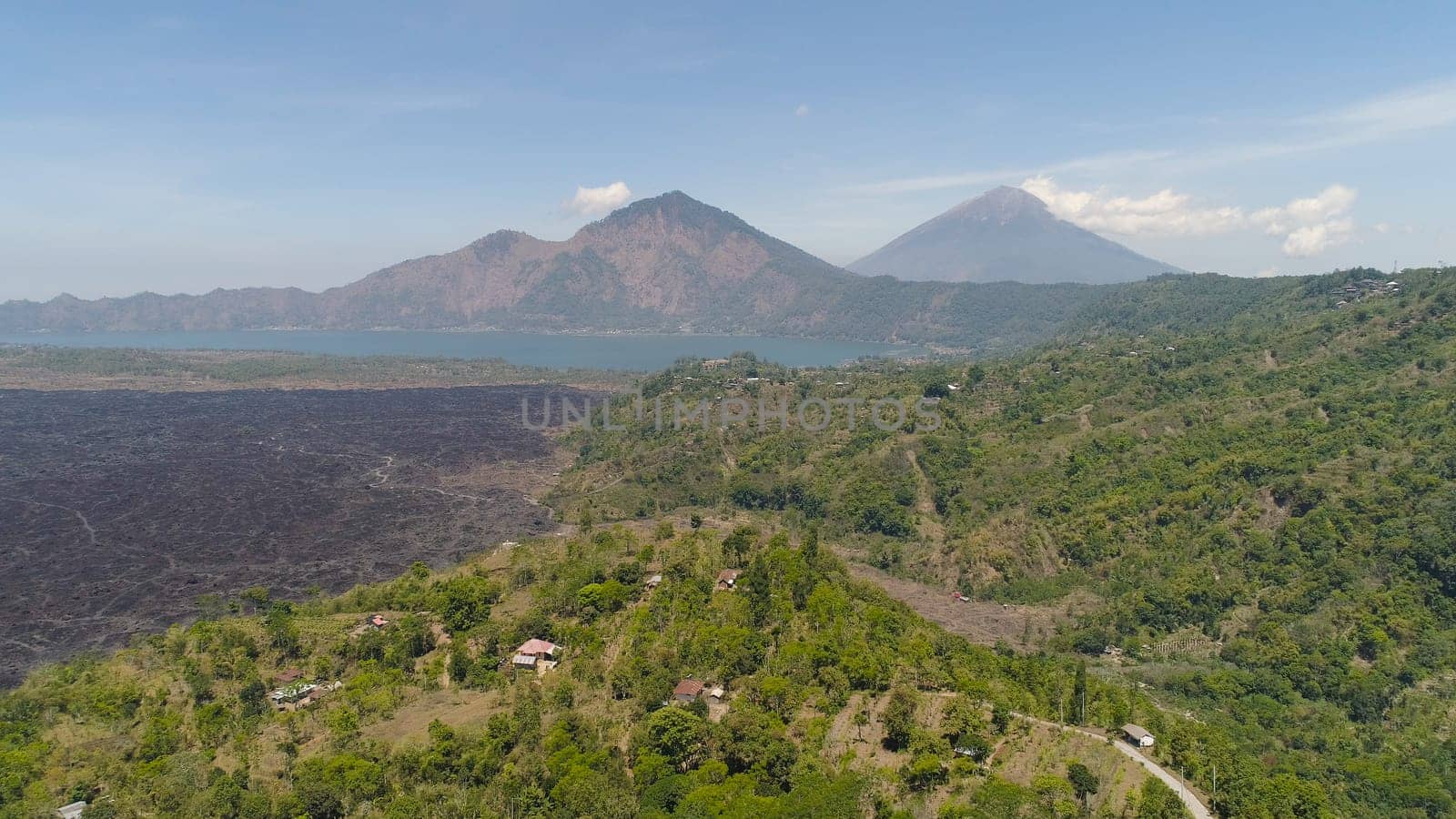 Aerial view volcano batur covered with vegetation mountain landscape with volcano sky and clouds Bali, Indonesia. Travel concept.