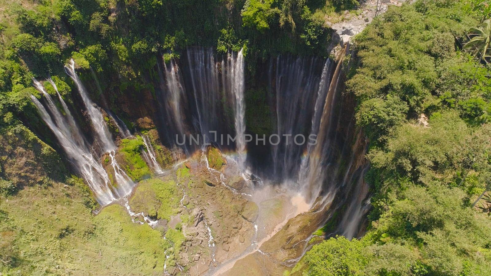 beautiful waterfall Coban Sewu in tropical forest, Java Indonesia. aerial view tumpak sewu waterfall in rainforest