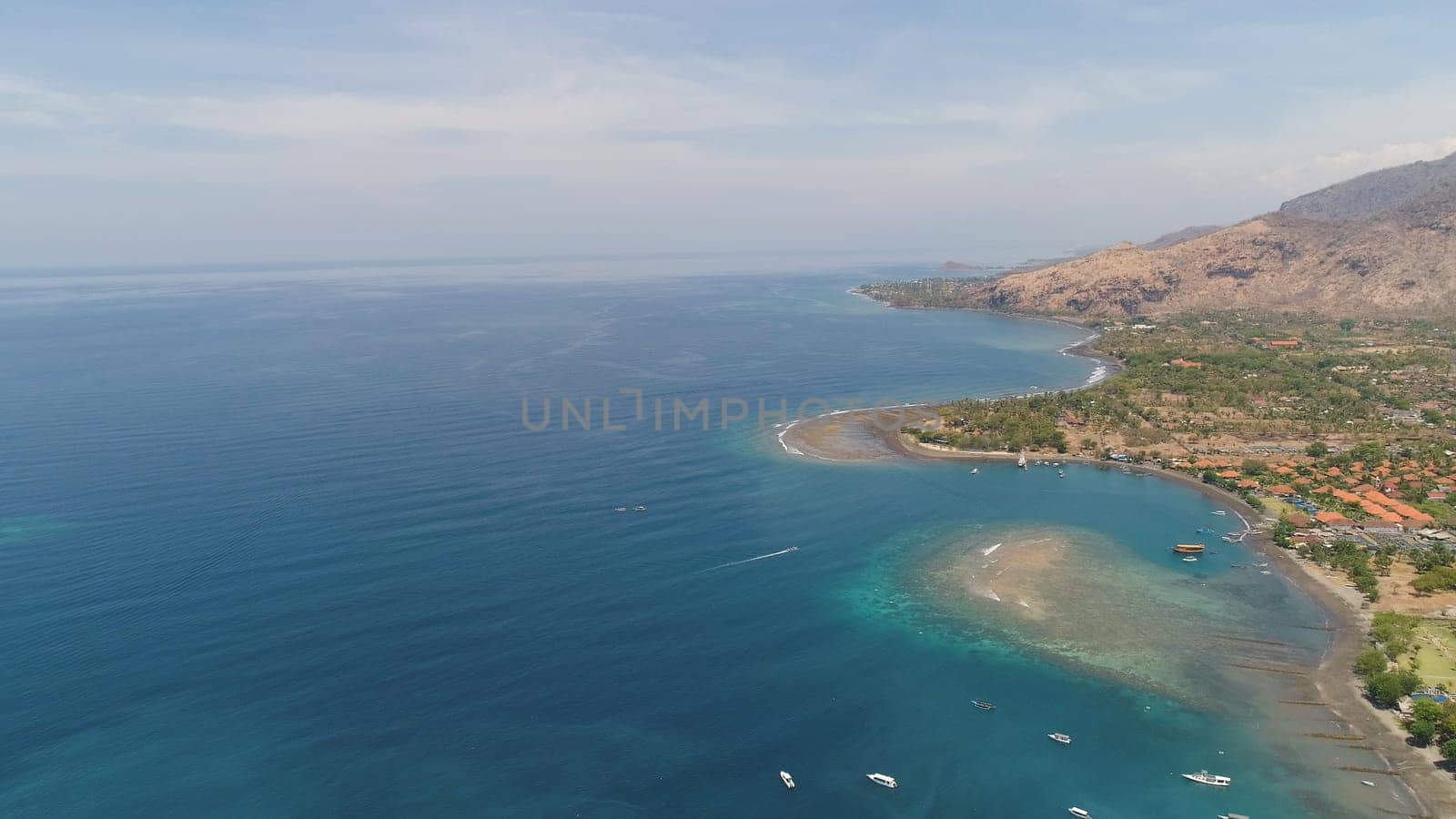 sea coast with tropical beach. aerial seascape tropical landscape, sea, boats on the surface water. Bali,Indonesia, travel concept.