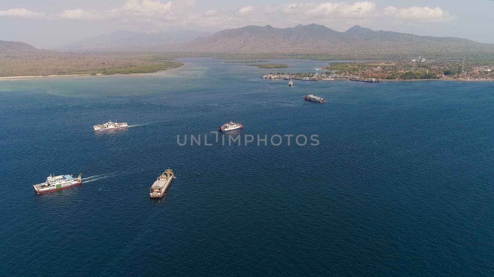 public ferry ships carrying passengers from Gilimanuk harbour ferry port in Bali Island to Ketapang harbour East Java, Indonesia