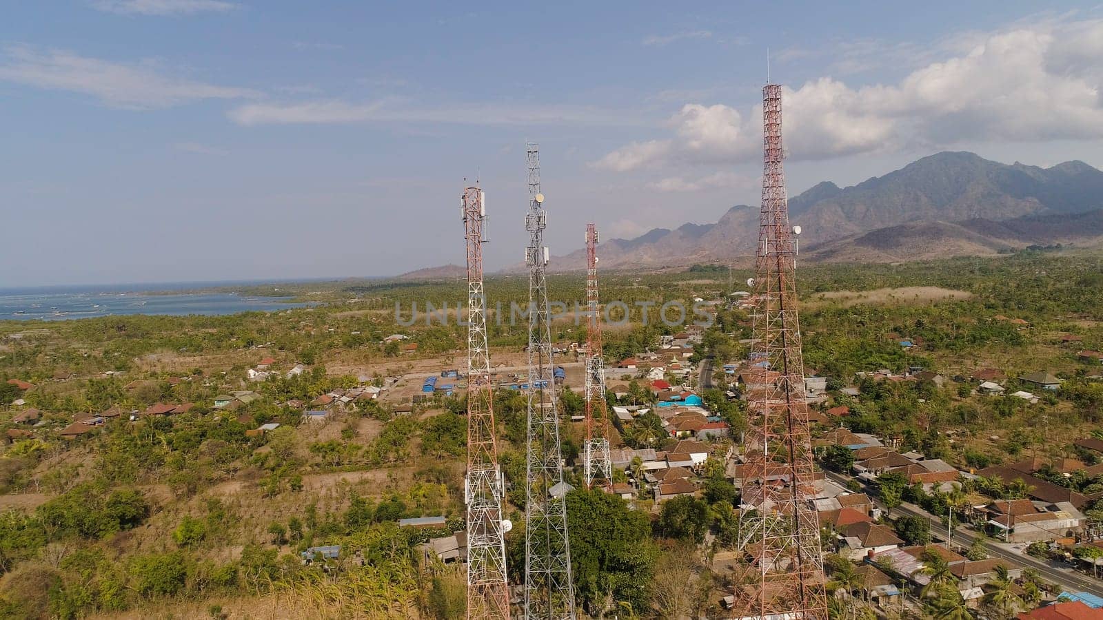 aerial view cell phone towers line in bali, indonesia. Telecommunication tower, communication antenna on coast sea