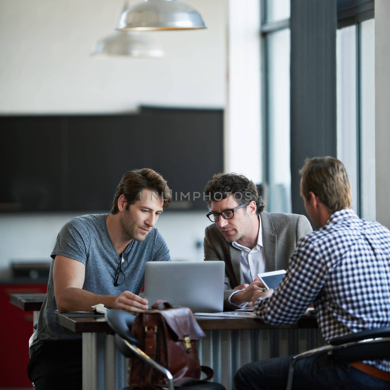 Colleague, laptop and office for web project, career and discussing online email feedback on digital report. Mature people or professional person with tech for collaboration planning web on mockup.