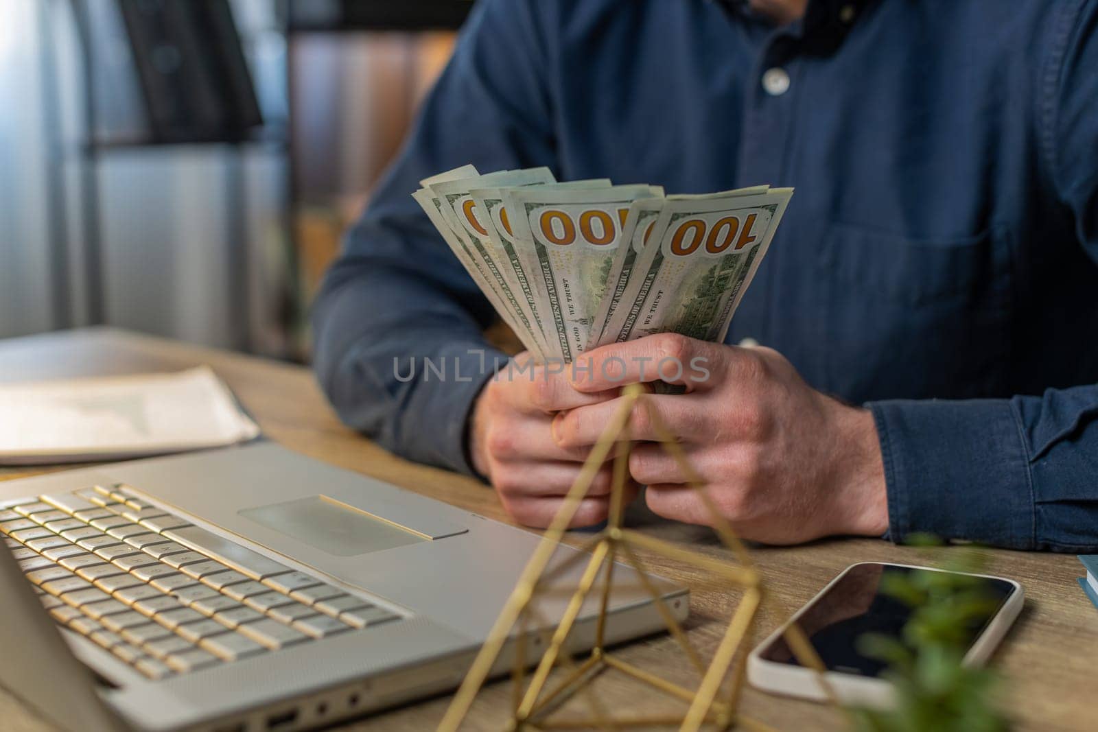 Close-up hands of businessman counting cash money dollar checking salary enjoy richness at modern workplace. Happy freelancer guy calculating currency profit financial savings at home office table