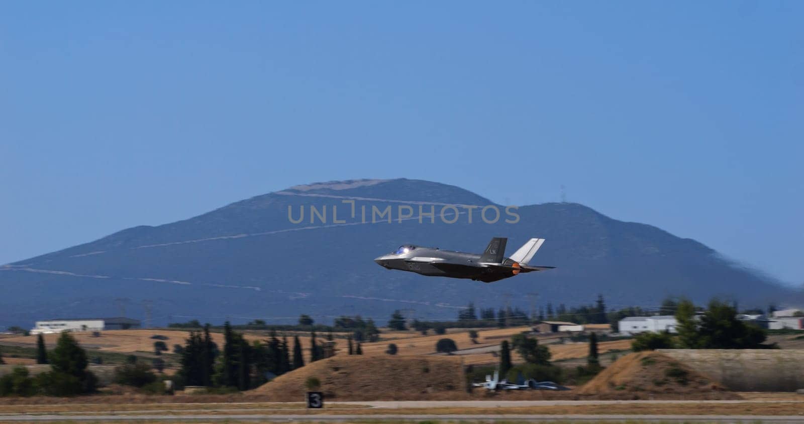 Athens Greece September 3 2023: US air force f-35 lightning ii jet flying with a mountainous landscape in the background. Space for text.