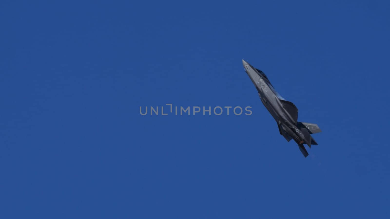 Athens Greece September 3 2023: Modern USAF Fighter Jet Climbing in Blue Sky with Afterburner. Lockheed Martin F-35 Lightning II of United States Air Force. Copy Space