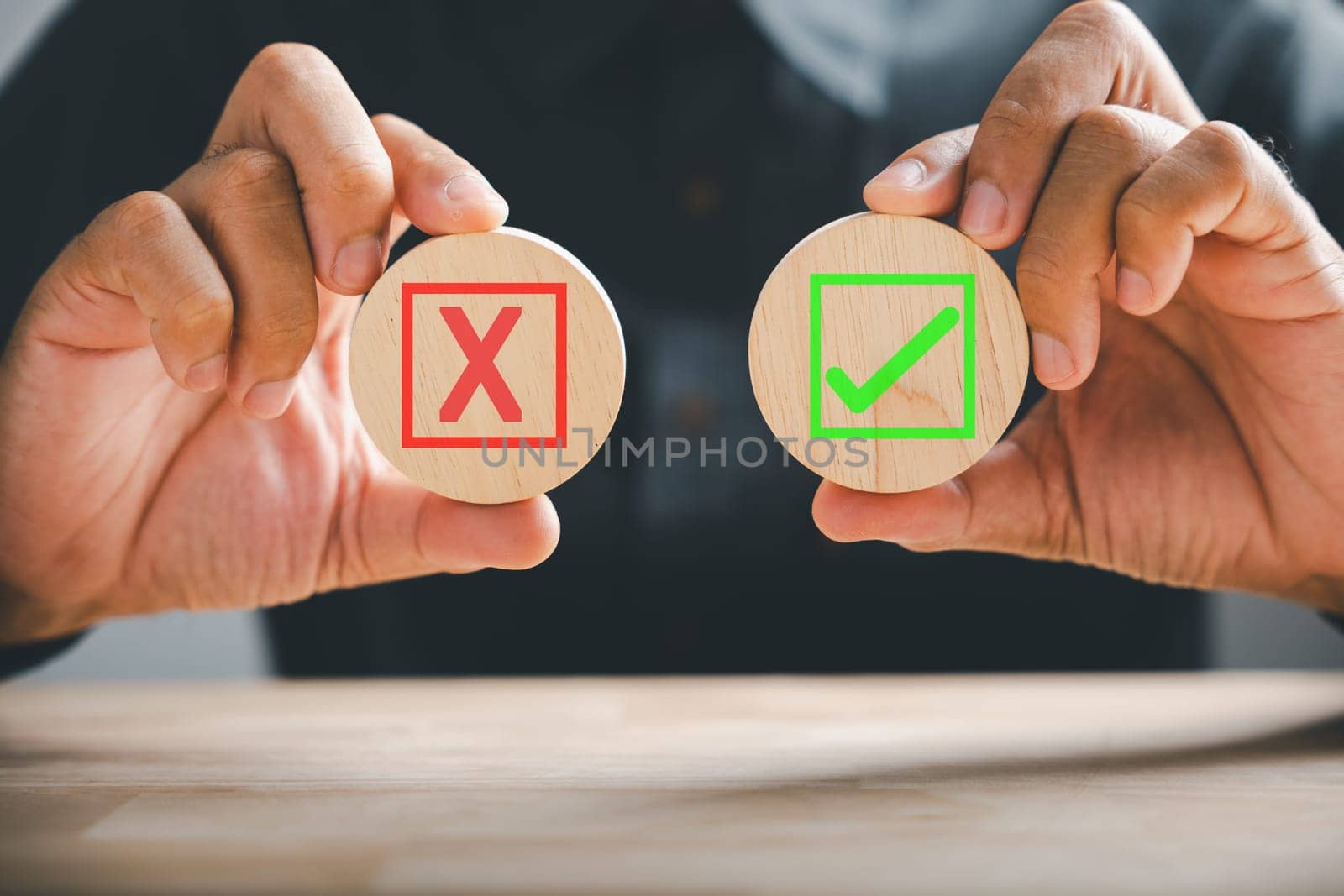 Wooden cubes held by hand, green checkmark and red cross represent yes or no options. Depicts true and false symbols for evaluation purposes. Think With Yes Or No Choice.