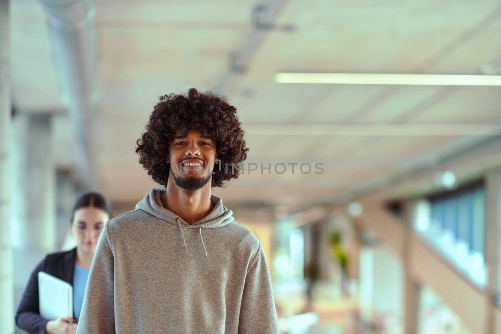 In a modern office environment, an African American young entrepreneur engages in work, while in the background, his dedicated colleagues exemplify teamwork and collaboration, encapsulating the essence of contemporary corporate success.