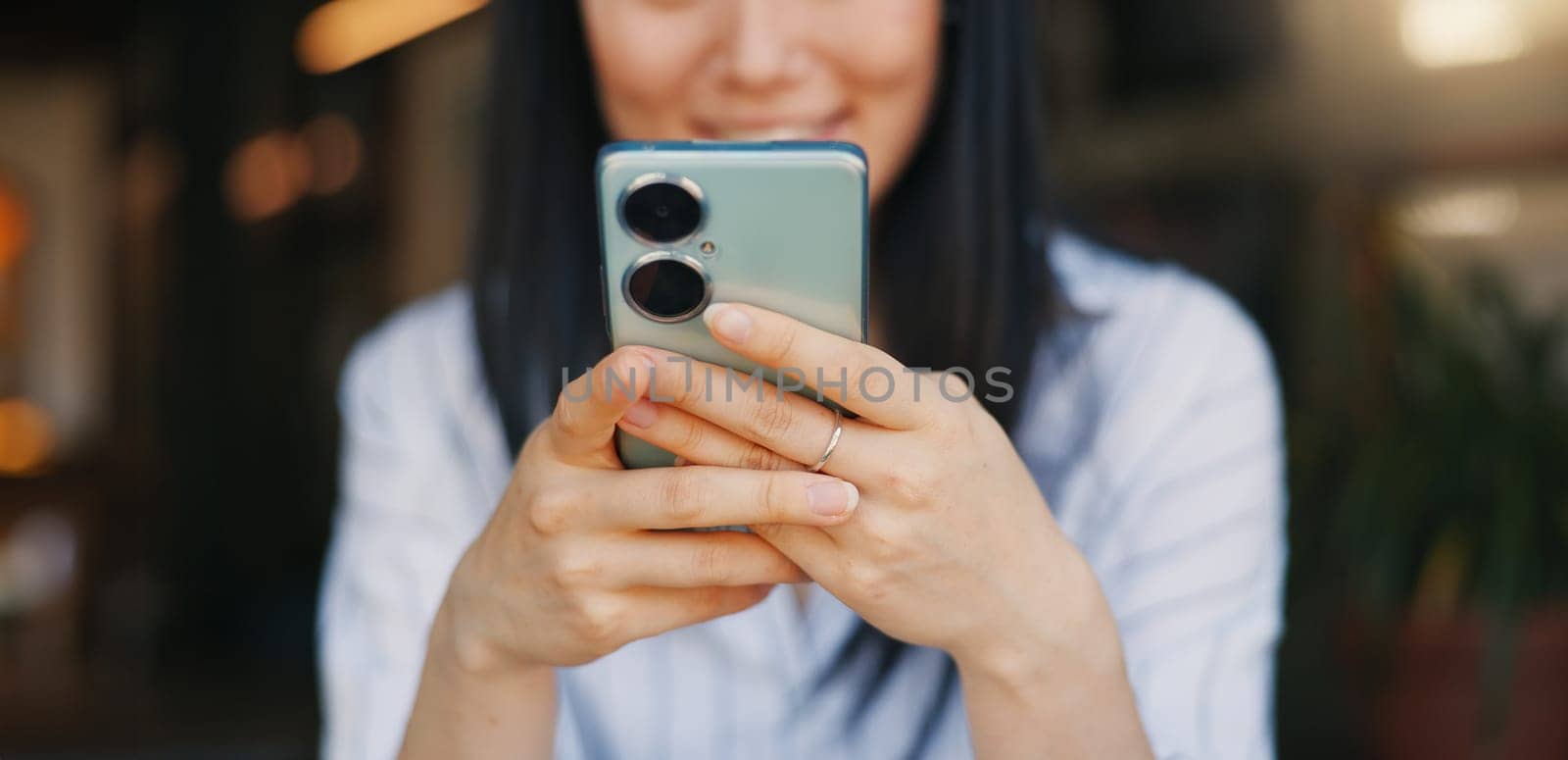 Hands, woman and phone for texting, closeup or happy for funny video, meme or comic web blog. Girl, Japanese person and smartphone for typing, scroll or click for reading notification on social media.