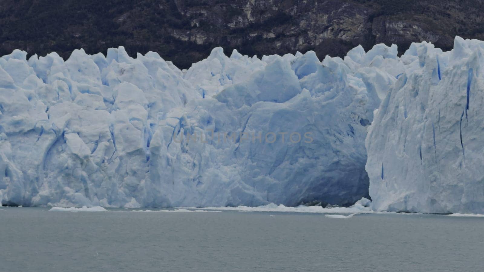 Boat tours mesmerizing glacier with ice caves in arctic scenery.