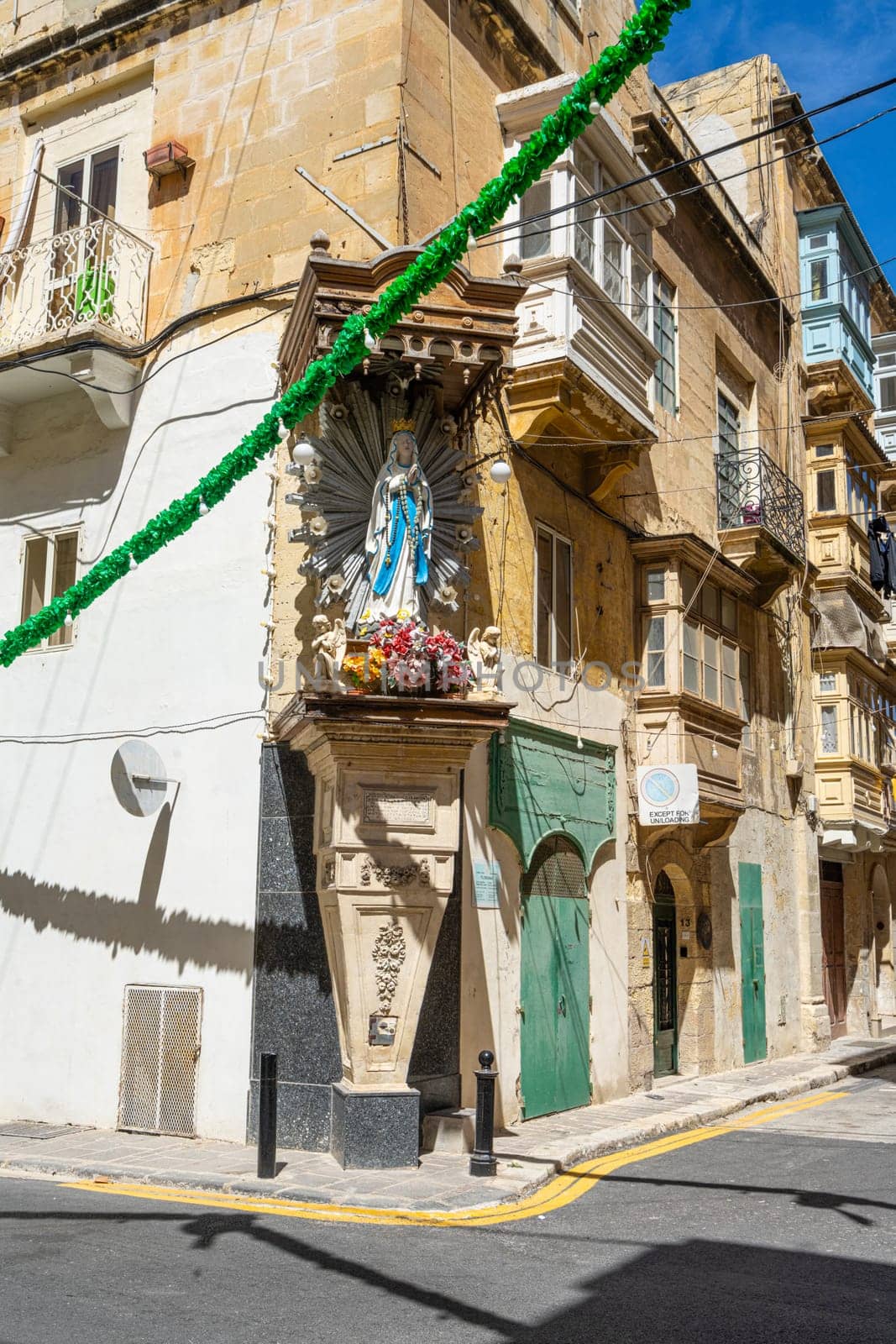 Valletta, Malta, April 03, 2024. a typical religious statue in the corner of the historic center of the city