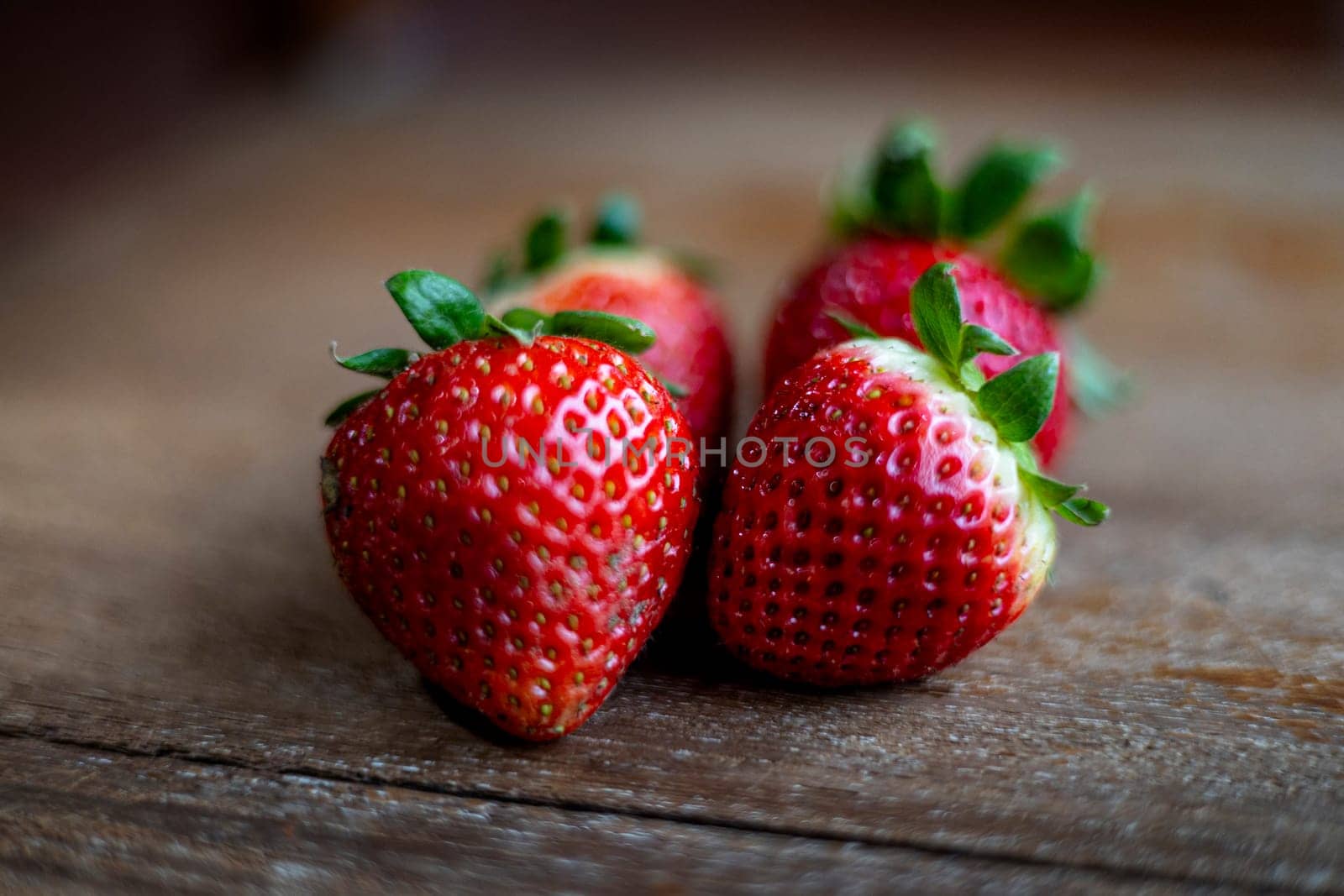 Healthy food. Fresh ripe strawberries on a brown texture background. Fresh organic strawberries on old wooden.