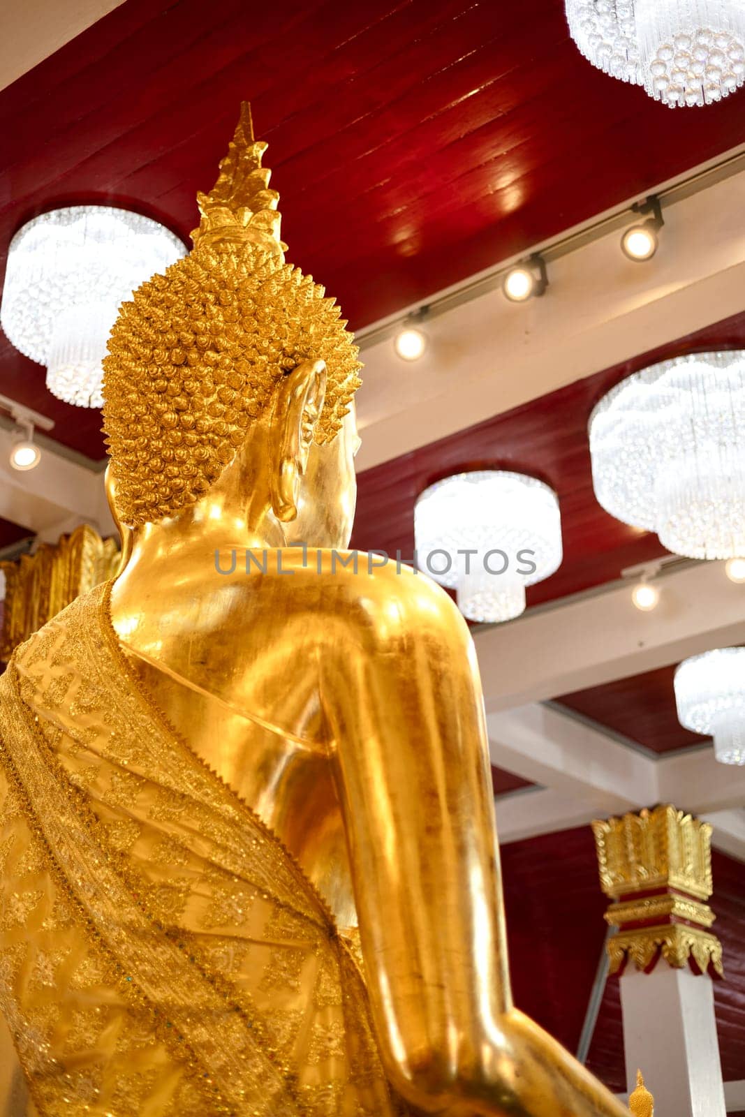 Behind Of Golden Buddha Statue. Golden Buddha behind faces statue meditation sitting with lamp background.