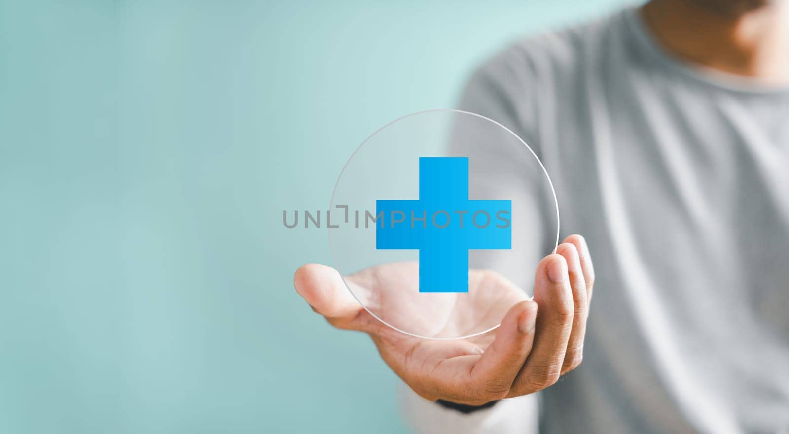 Hand grasps plus icon for healthcare, symbolizing benefits. Health insurance health concept, access to welfare health with empty area. Conveys value addition in medical services.