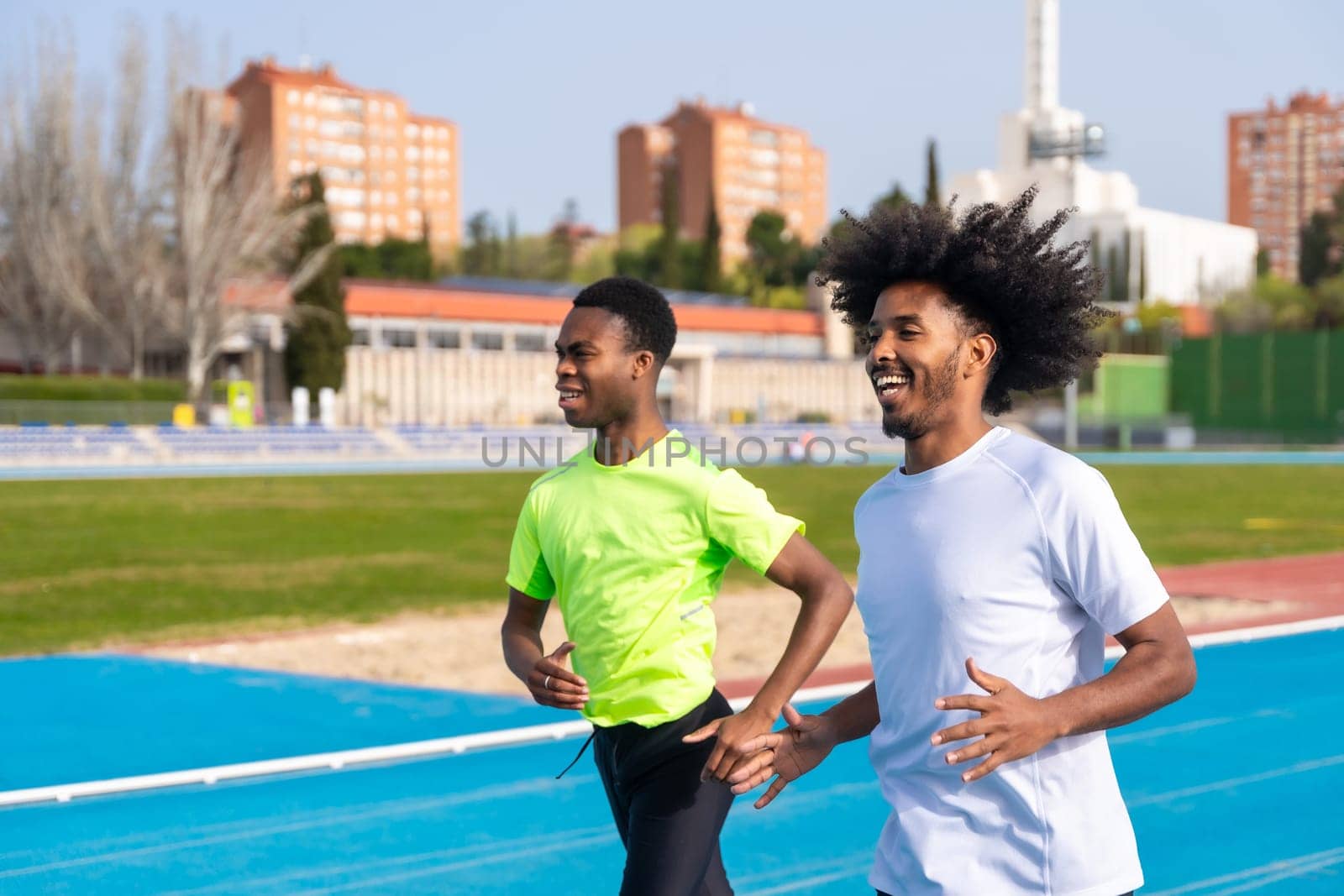 African american young runners in an outdoor track by Huizi
