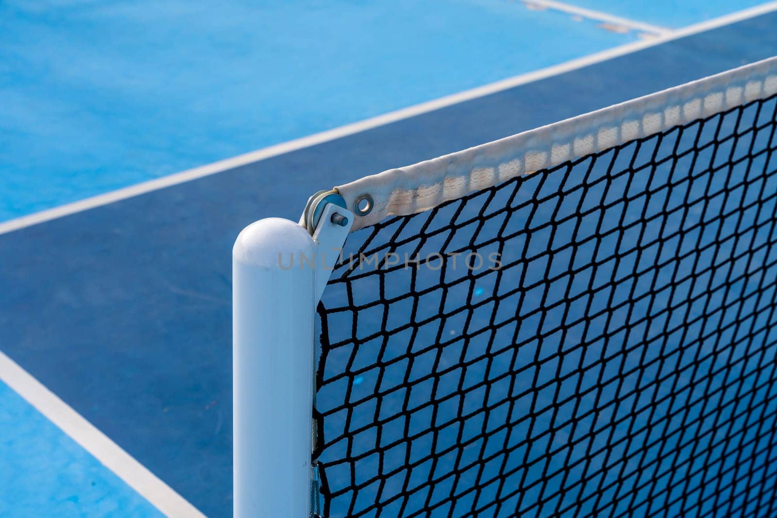 Detail of a new tennis net on a pickleball court by Huizi