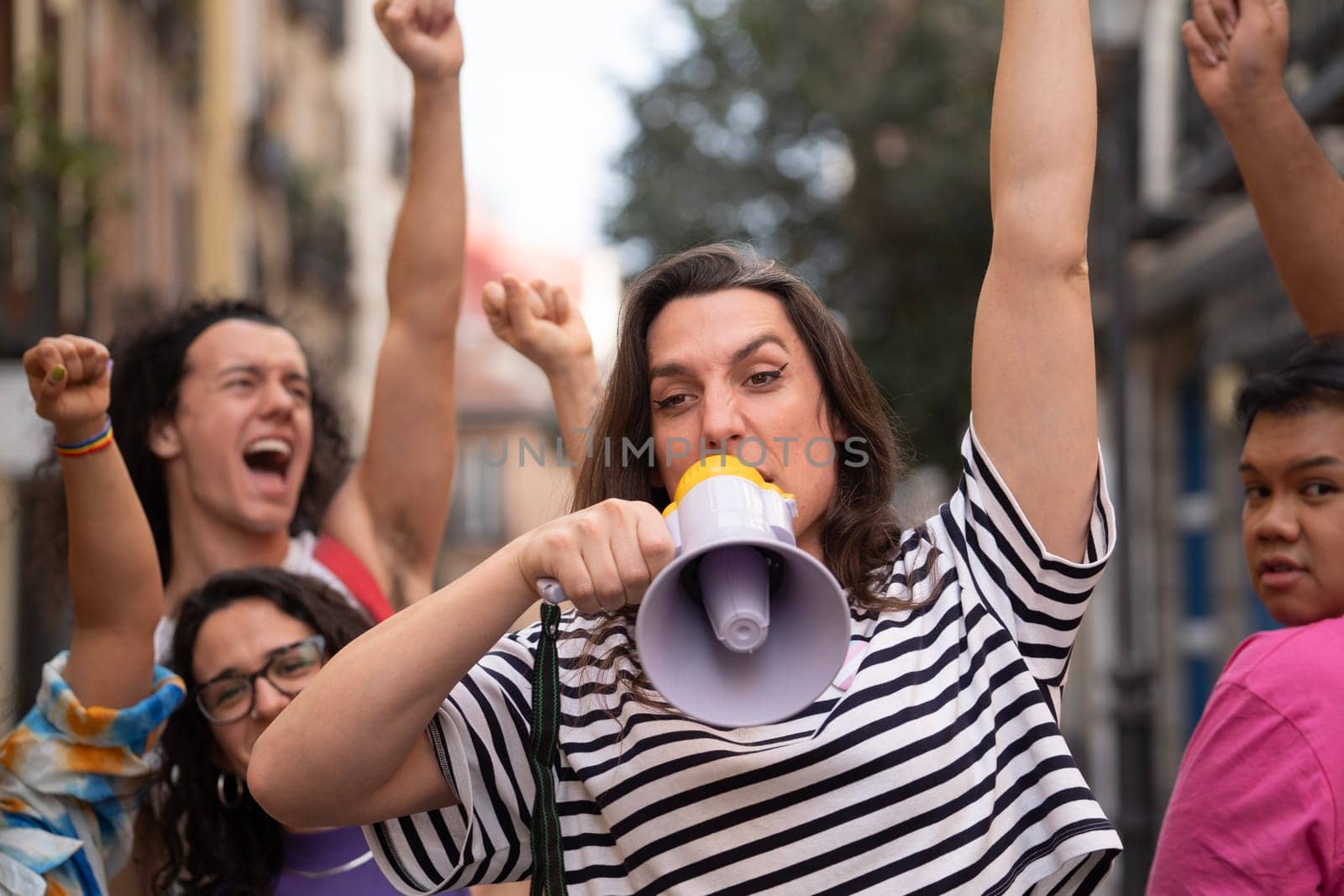 Transgender woman screaming during a protest to support LGBTQ community. Horizontal by papatonic