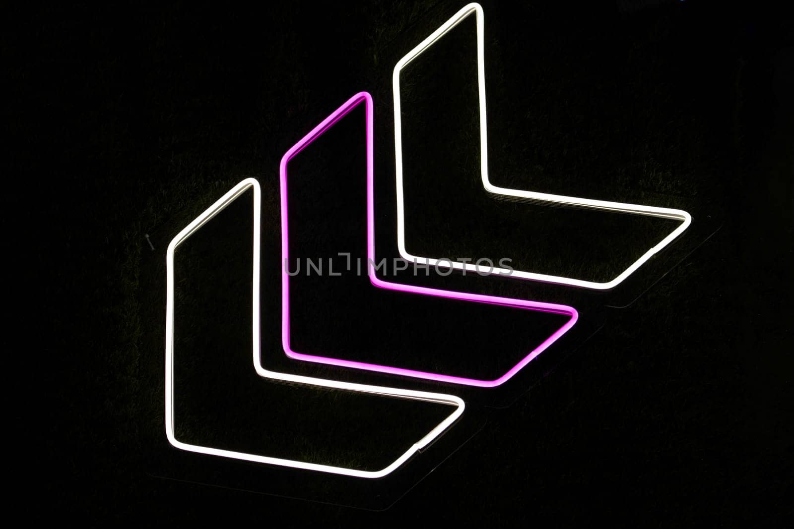 neon direction sign on black background by drakuliren