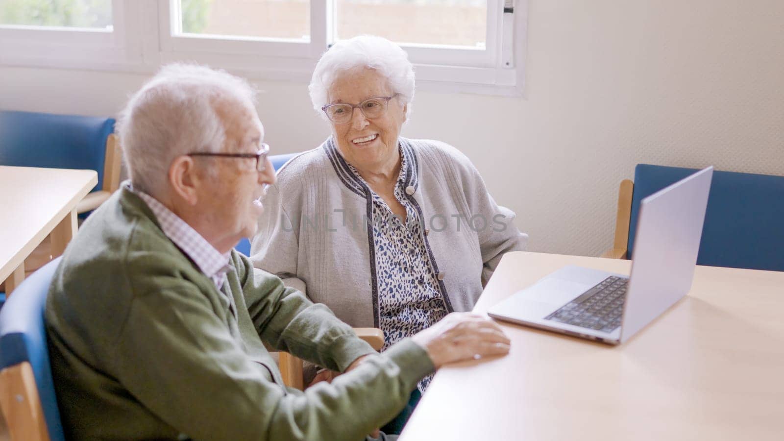 Senior people smiling during a video call from a nursing home