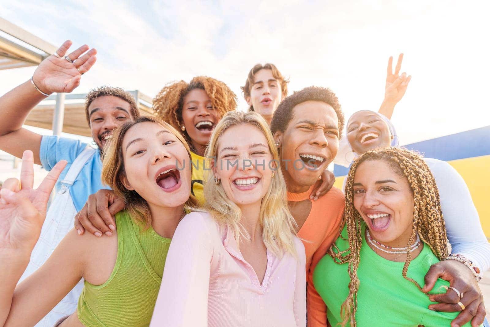 Happy blonde caucasian woman taking selfie with multiethnic friends outdoors