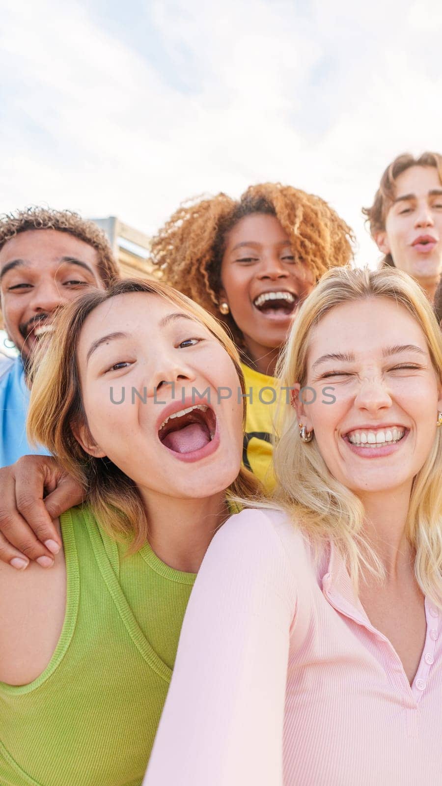 Multiethnic group of friends taking a happy selfie outdoors