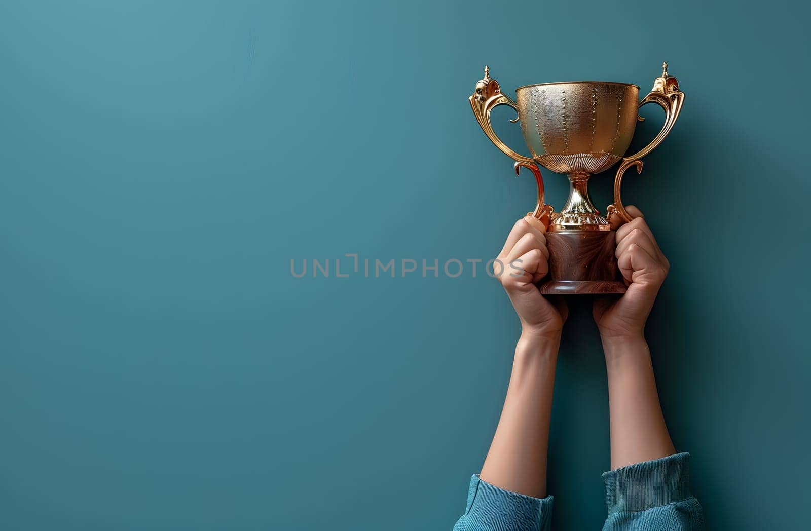 A person is triumphantly holding a gold trophy in their hand, their wrist positioned elegantly. The trophy gleams in the light, a symbol of victory and success
