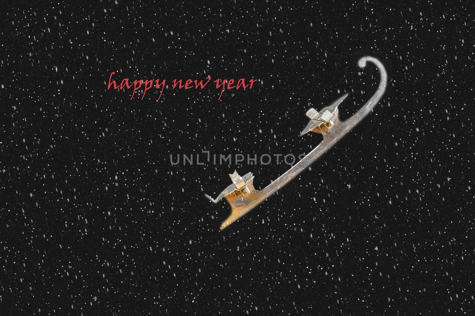 Vintage ice-skate on black background with snow effect. Text - Happy New Year. Copy space.