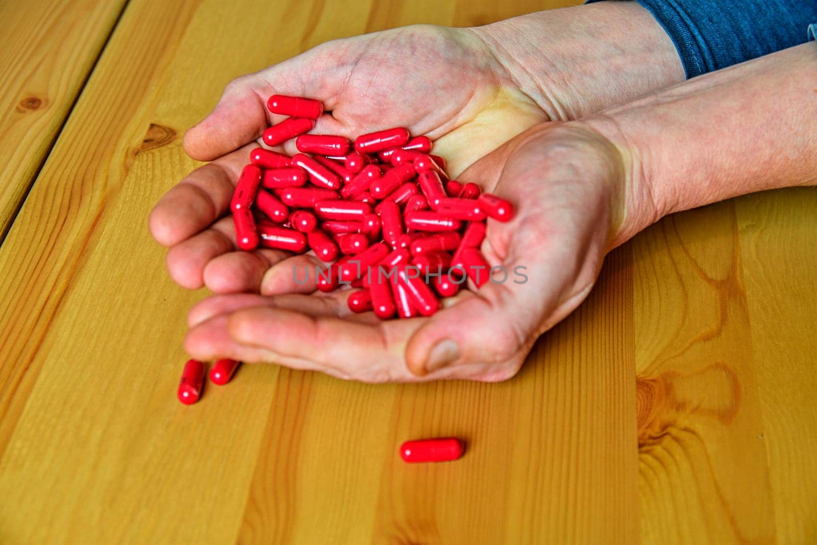 Many pills in a Senior's hands. Painful old age. Caring for the health of the elderly.