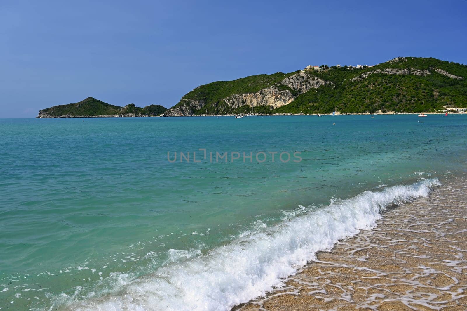 Beautiful beach with sea, sun and blue sky. Concept for travel and summer vacation. Greece-island of Corfu. Agios Georgios beach. by Montypeter