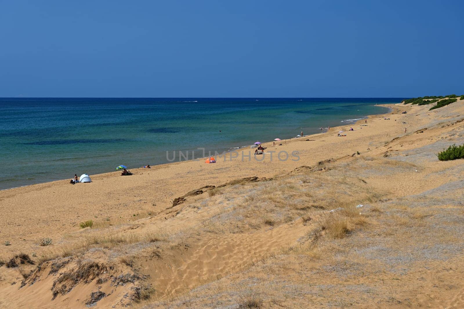 Beautiful beach with sea, sun and blue sky. Concept for travel and summer vacation. Greece-island of Corfu.