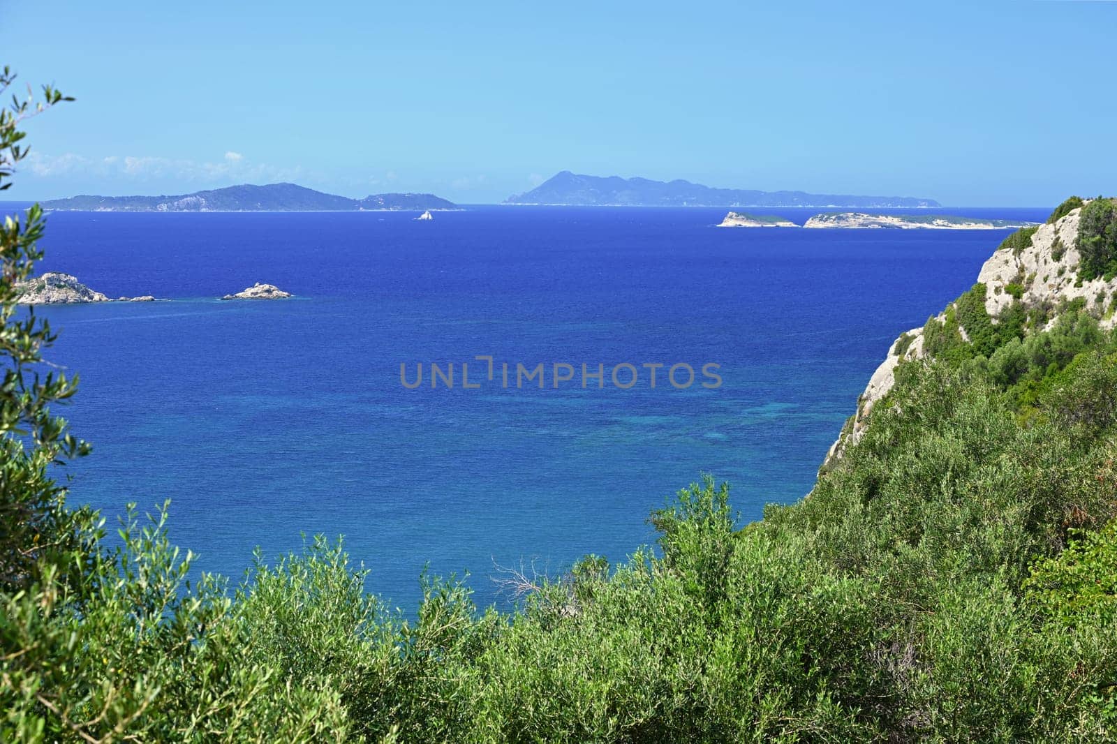 Beautiful beach with sea, sun and blue sky. Concept for travel and summer vacation. Greece-island of Corfu. by Montypeter