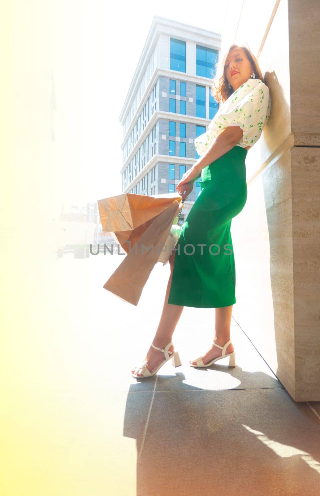 Front view portrait of a beauty woman walking holding shopping bags by kajasja