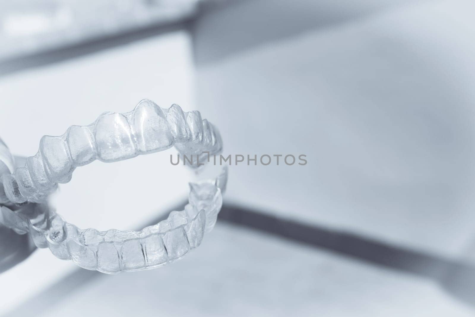 Invisible teeth aligner on light background. No people