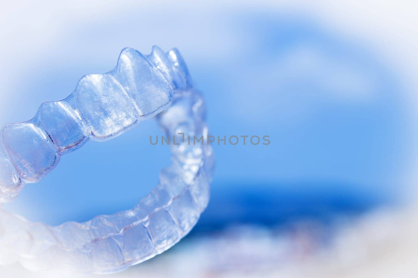 Invisible teeth aligner on light background. No people