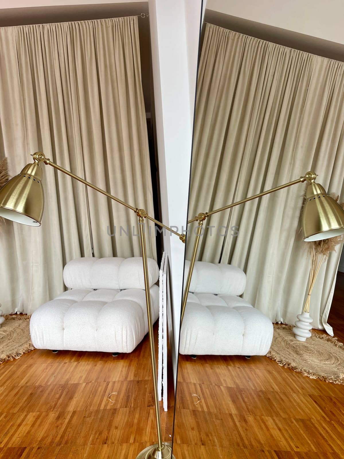 Reflection of a part of the interior with a lamp and an upholstered chair in the mirror. High quality photo