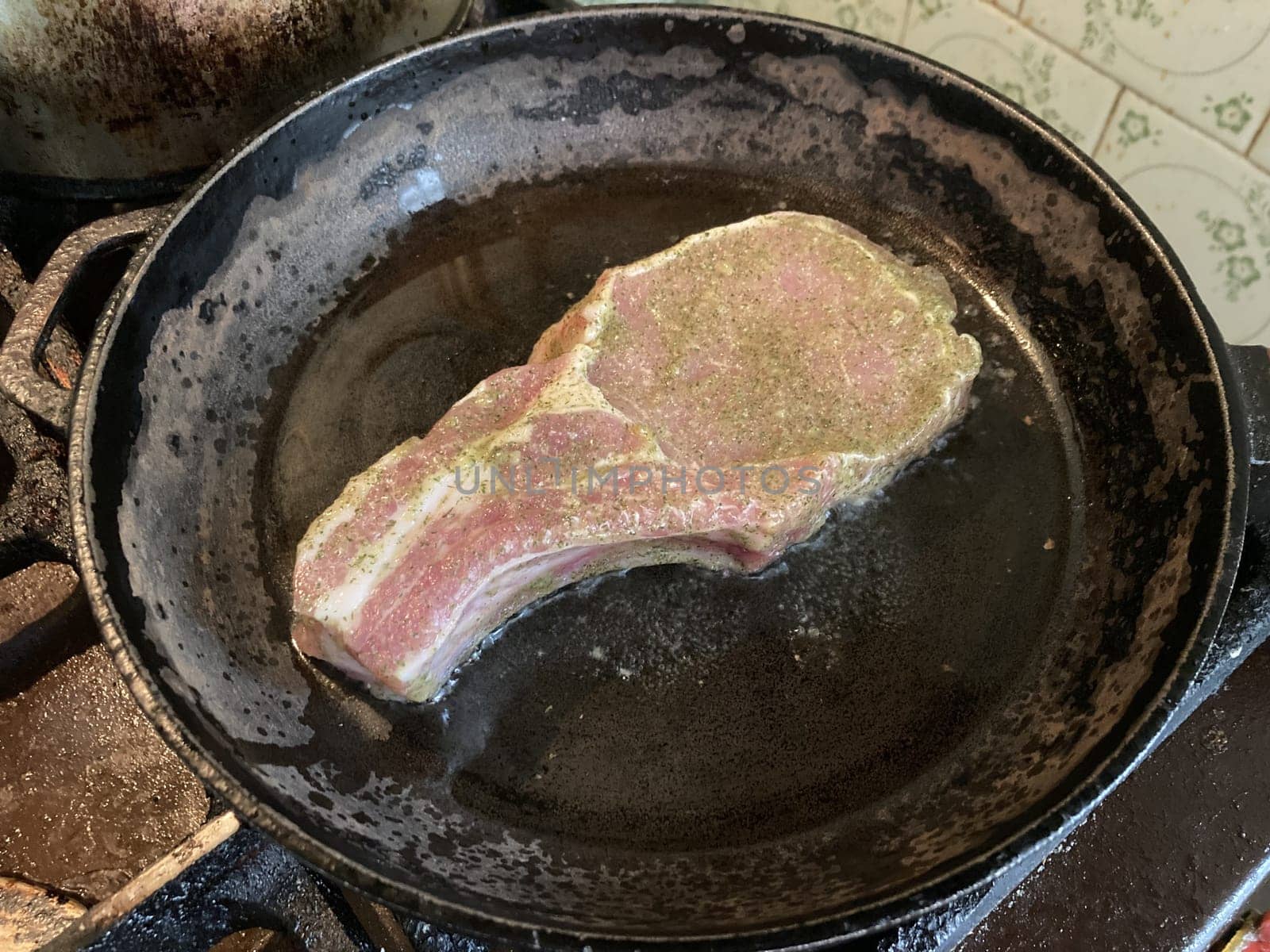 Fried and braised pork steak in a the thefrying pan