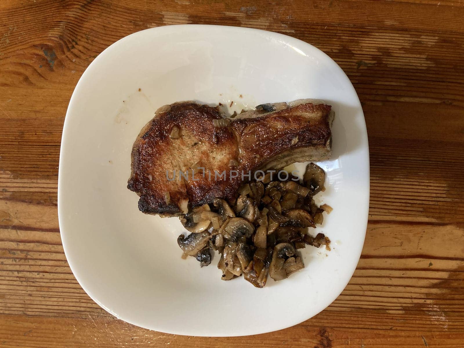 Fried and braised pork steak in a the thefrying pan