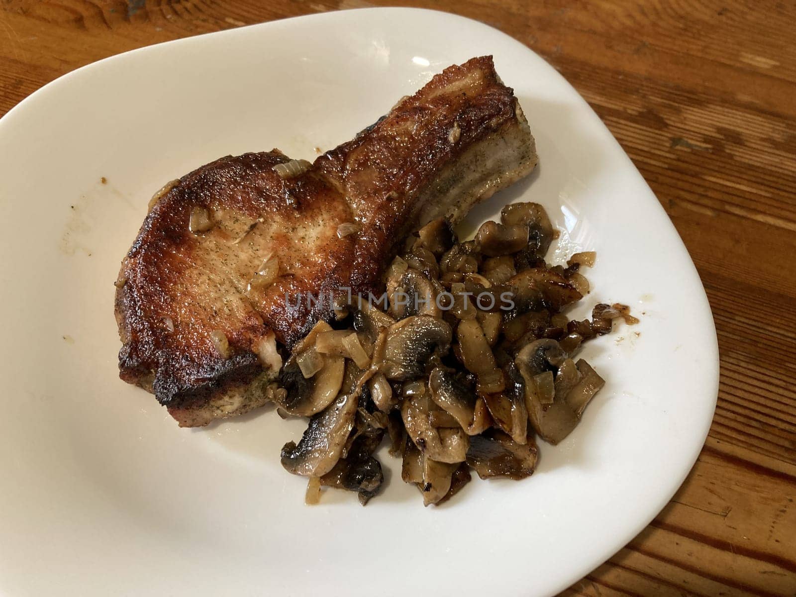 Fried and braised pork steak in a the thefrying pan