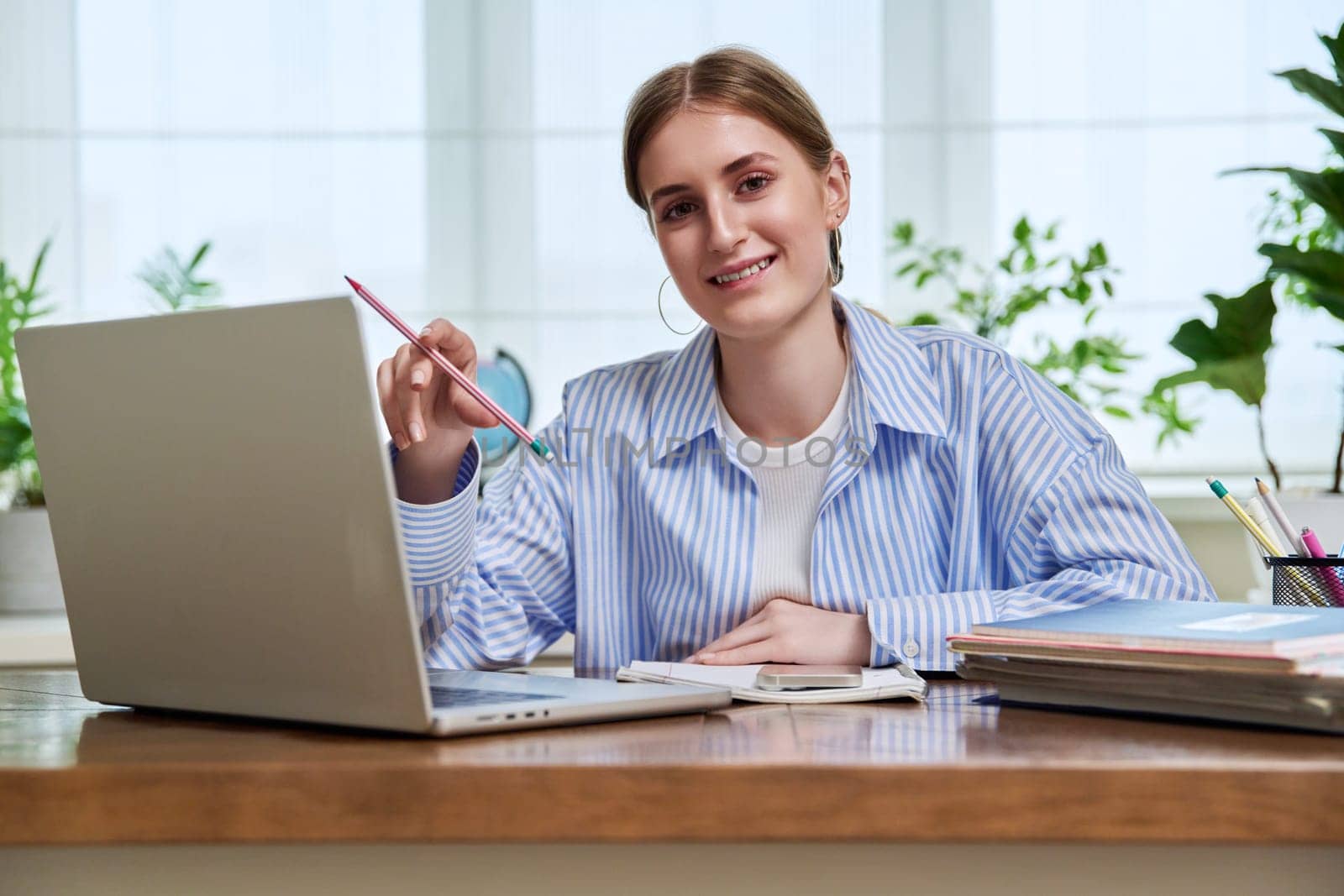 High school, college student smiling young female sitting at desk with computer by VH-studio